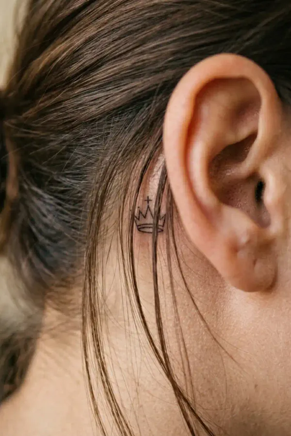 Chess tattoo behind the ear, profile view