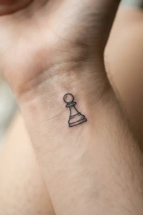 Macro shot of a tiny chess tattoo on the wrist